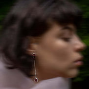 Long silver earring with a stone
