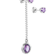 Long silver earring with a stone