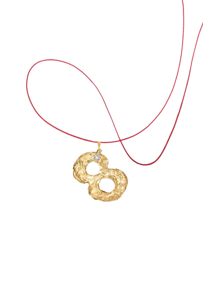 Gold number 8 pendant with a diamond. 14k gold