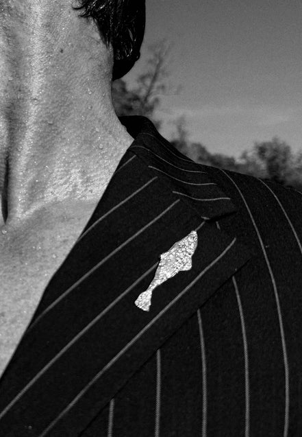 Silver fish-themed pin